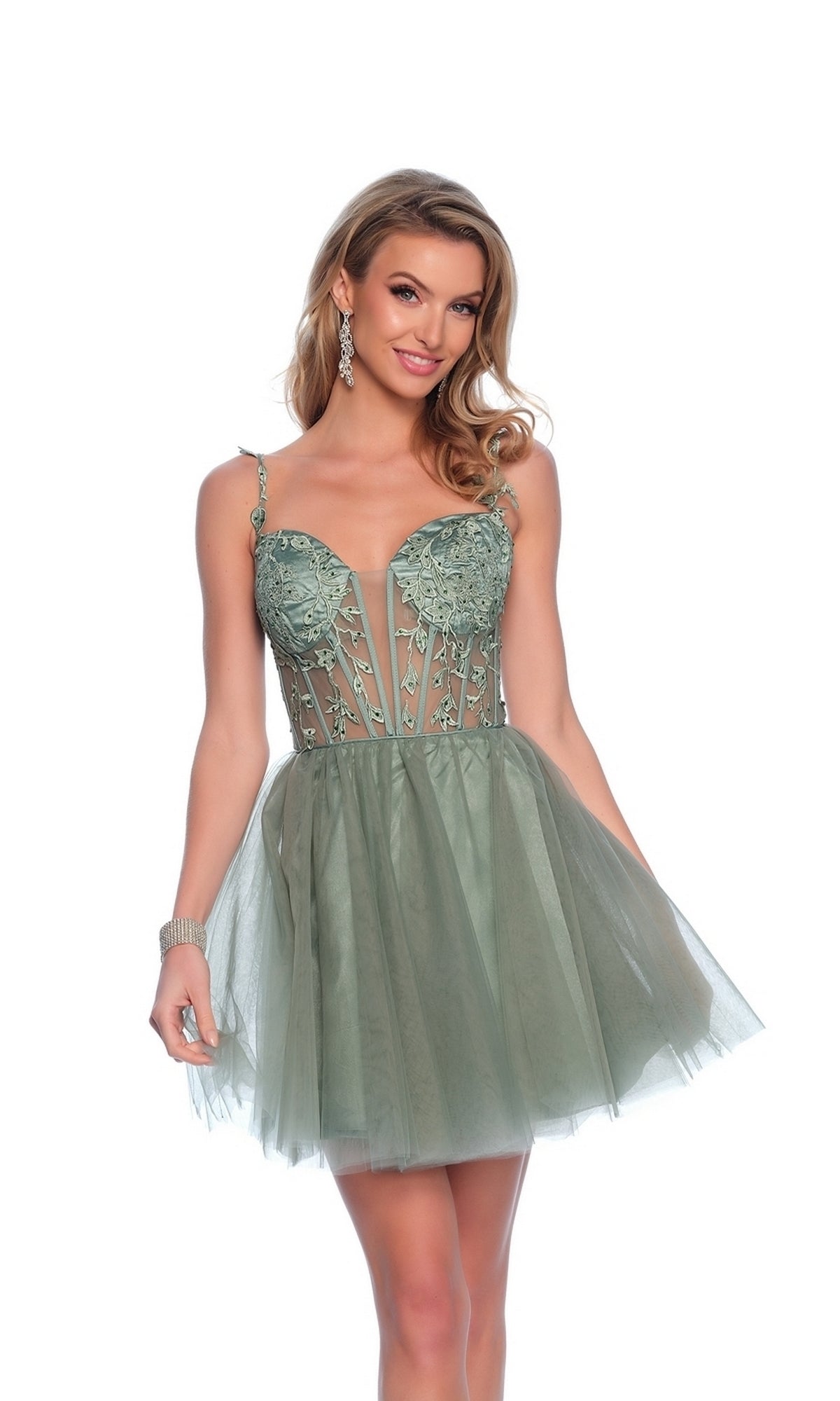 A woman poses and smiles against a white background, wearing the Dave & Johnny 11920 Sage Green Homecoming Dress with a fitted embellished corset bodice, spaghetti straps, and a short tulle A-line skirt.